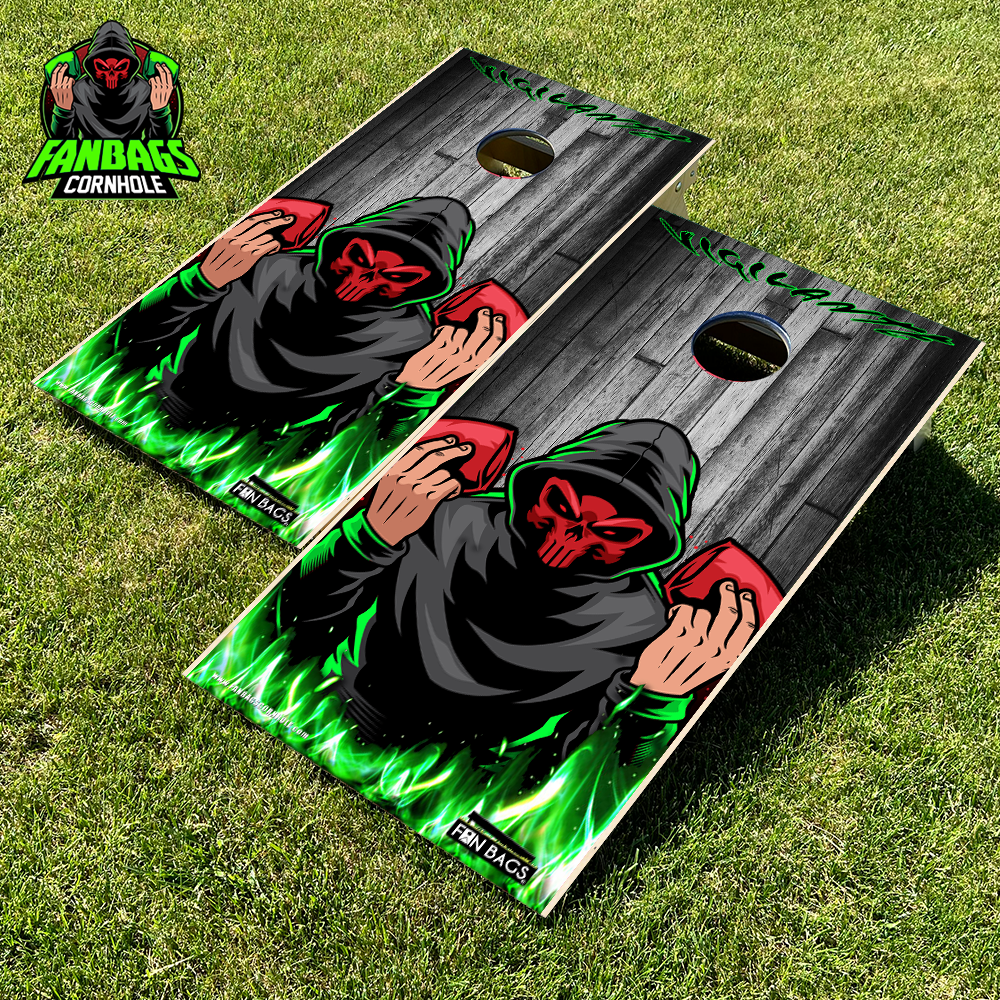 a set of cornhole boards sitting in grass with a Fanbags logo