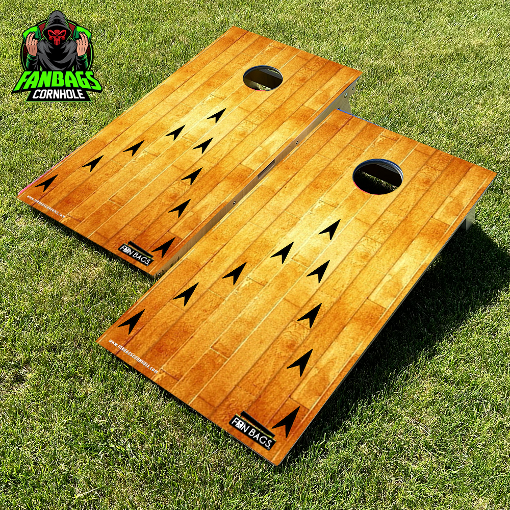 a set of cornhole boards sitting in grass with a bowling alley design