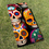 Thumbnail: Sugar Skull design printed directly on a cornhole board sitting in the grass