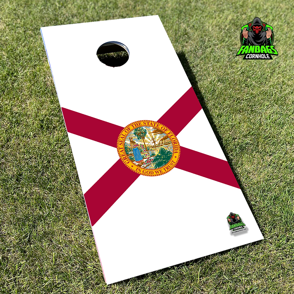 a set of cornhole boards sitting in grass with a state flag