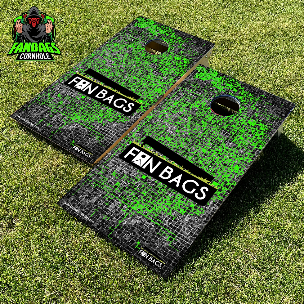 a set of cornhole boards sitting in grass with a green Fanbags logo