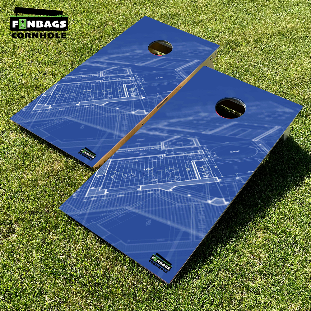A pair of tournament-style cornhole boards made from smooth Baltic birch wood, featuring a detailed architectural blueprint