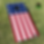 american flag printed on a Cornhole board sitting in grass