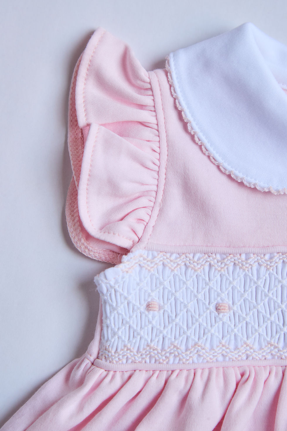 Thumbnail: Pink smocking embroidery detail on heirloom baby girl dress, pima cotton by Gabby Lou Baby