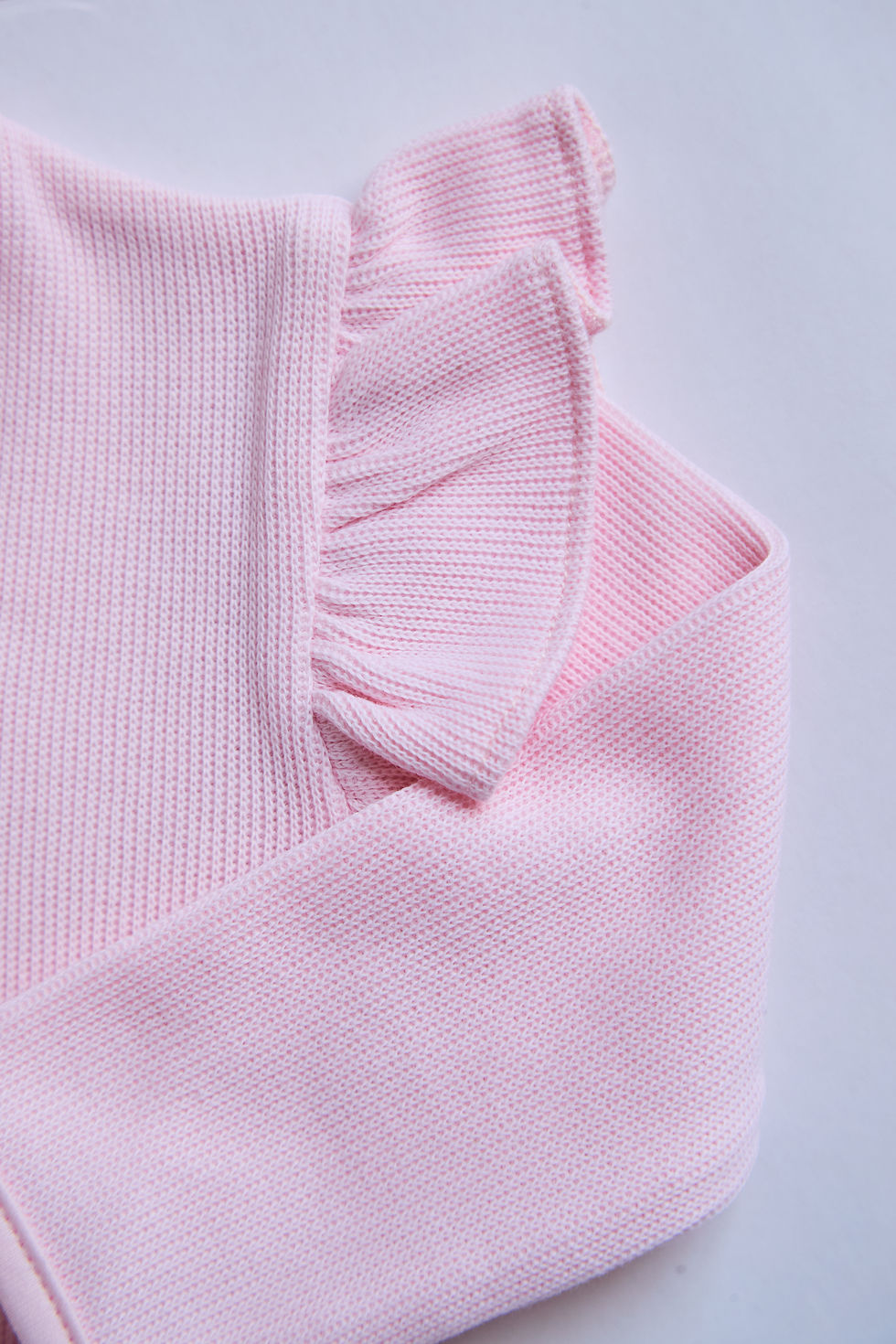 Thumbnail: Close-up of ruffle back shoulder detail on Baby Pink Ruffled Onesie in Pima cotton