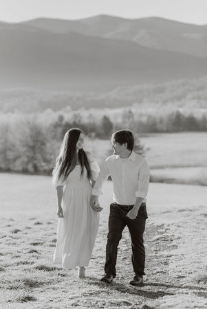 couple holding hands during engagement photoshoot at cades cove in Tennessee