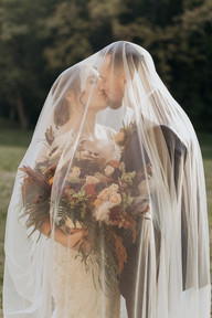 Bride and Groom pose in front of The Side Porch Wedding Venue