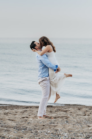 Couple has beach picnic with champagne glasses to celebrate their Engagement in Chicago