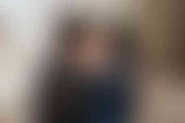 couple being playful kissing in forest at engagement photos at cades cove in tennessee