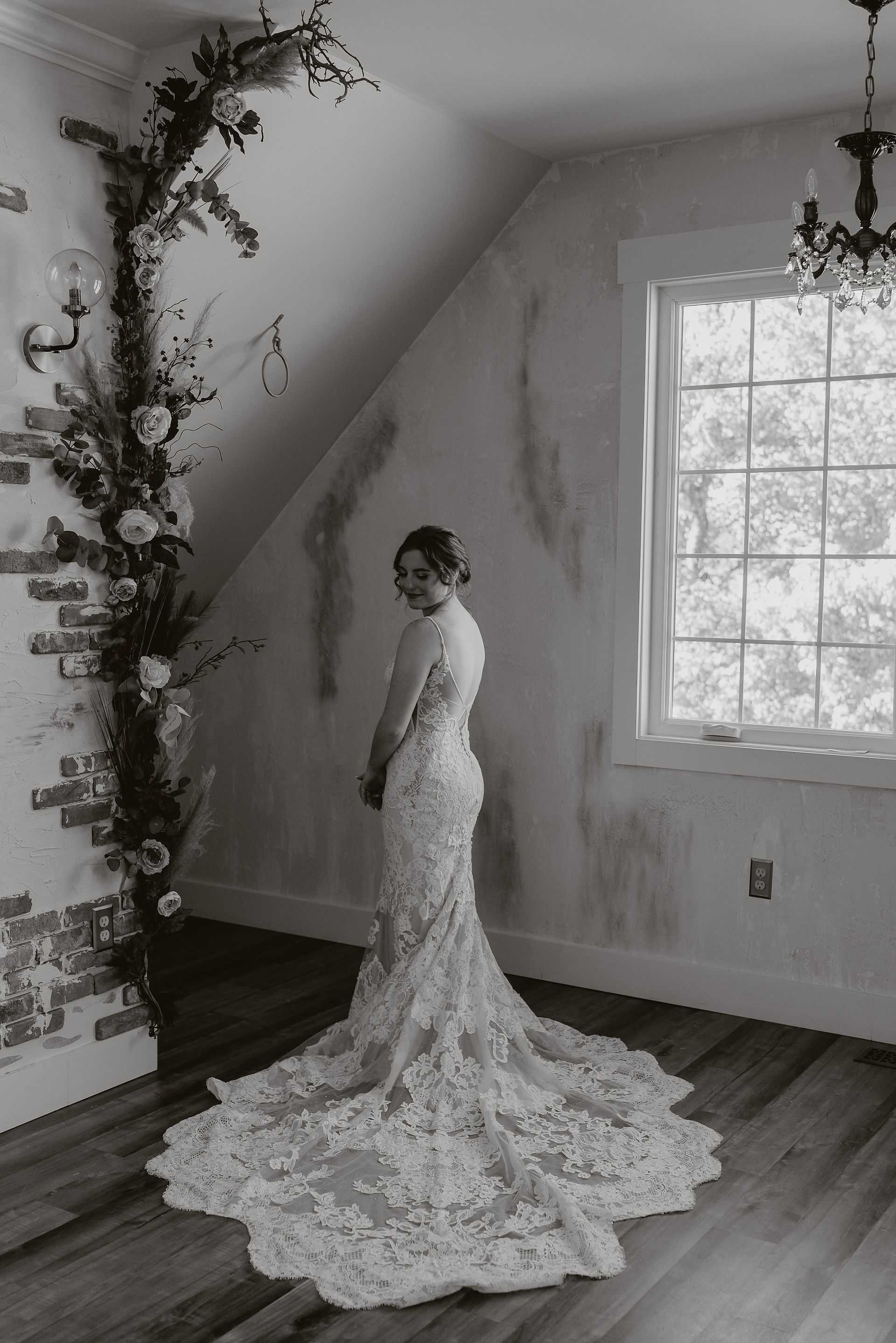 Bride puts on wedding dress and stands in bridal suite at The Side Porch Wedding Venue in Johnson City Tennessee