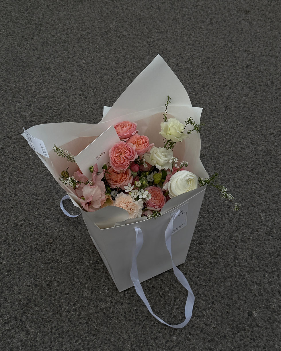 Soft pink-toned seasonal hand-tied bouquet with a balanced, elegant silhouette and Korean-style wrapping