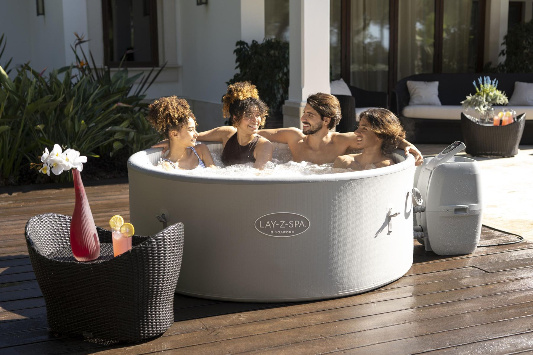 lay z spa singapore with 4 people sat in it