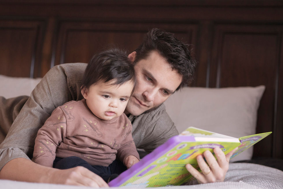 father reading a children's book to his little son