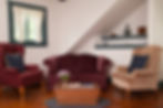 The sitting area in the Beatrice suite has two armchairs, a loveseat, and a coffee table.