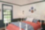 The Susan suite has bright white walls and a queen-sized bed.