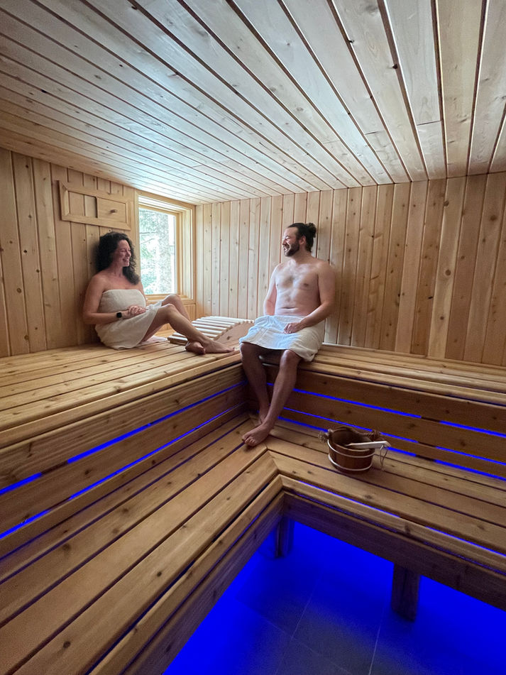 2 people sitting in the Sauna at the Featherbed Inn & Nordic Spa