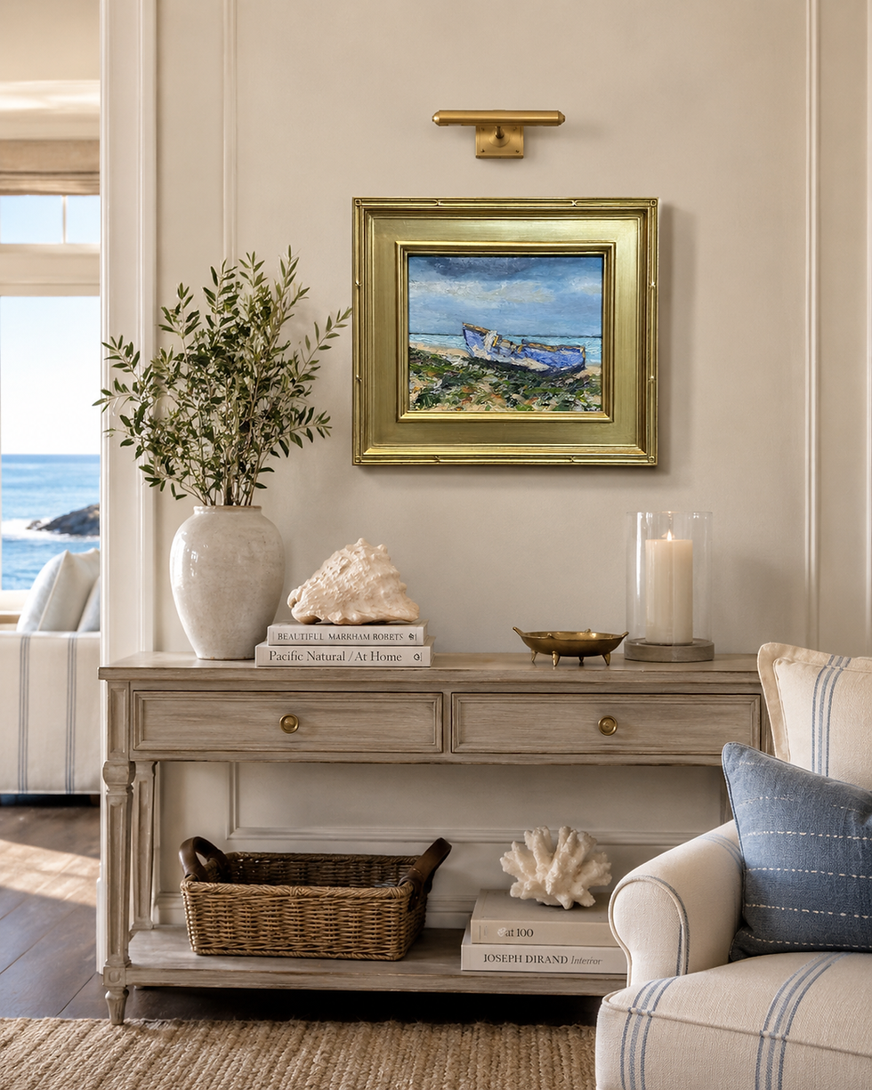 Thumbnail: Installed contemporary oil painting of a shipwreck on a cream wall above a rustic console table in a bright coastal room.