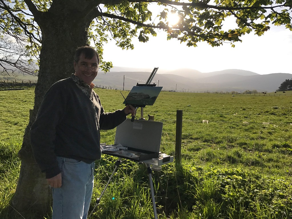 Artist Geoffrey C. Smith painting en plein air on a sunny day in a grassy area of Glenesk, Scotland