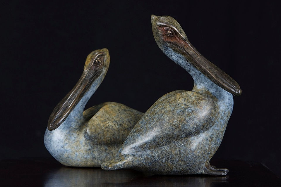 Sandsprit and Lucie bronze sculptures by Geoffrey Smith depicting two pelicans with one resting and one sitting