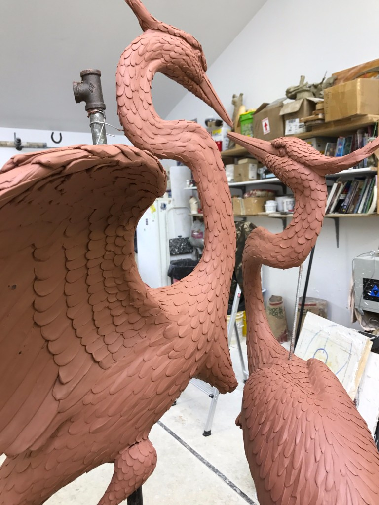 the great blue heron duet mold from the back showing the bodies of the blue herons and one facing forward and the other facing the first while in the foundry