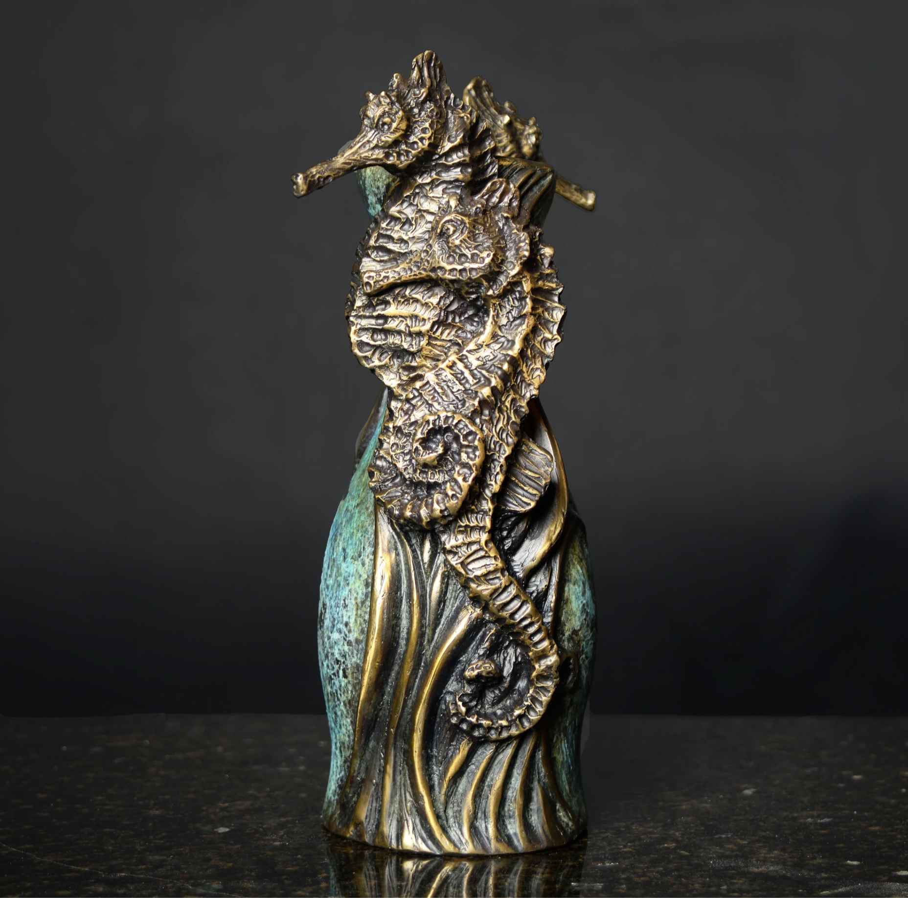 Detailed shot of hand-sculpted seahorses on Seahorse Vase bronze sculpture by Geoffrey Smith showing rich texture and patina