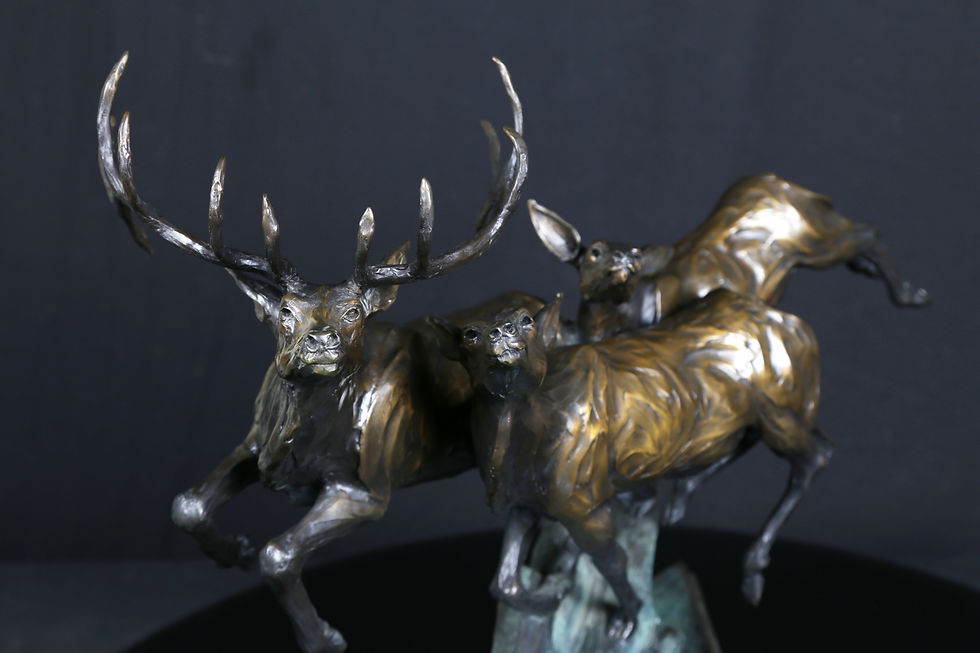 Thumbnail: bronze sculpture of a bull elk, cow, and calf running together in a dynamic forward motion