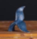 Humpback Whale Fluke bronze sculpture by Geoffrey C. Smith, featuring a rich blue patina on a studio surface.