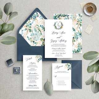 Modern wedding invitation suite featuring a foliage wreath with monogram and envelope liner with greenery and eucalyptus foliage