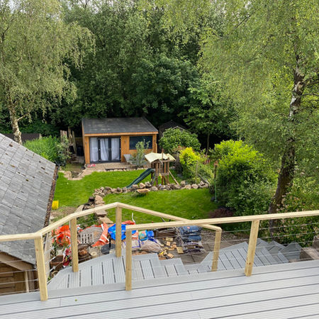 Lilly pad inspired composite decking with bespoke railings leading to timber clad garden room/office/gym