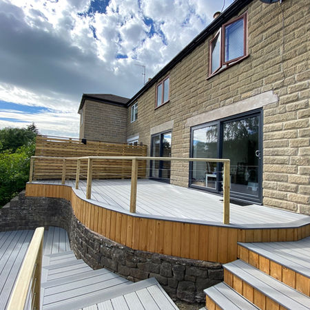 Lilly pad inspired composite decking with bespoke railings leading to timber clad garden room/office/gym