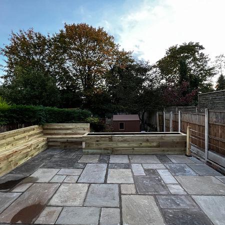 Limestone slab patio and sleeper planters in garden of Victorian home in Lady Bay, Nottingham