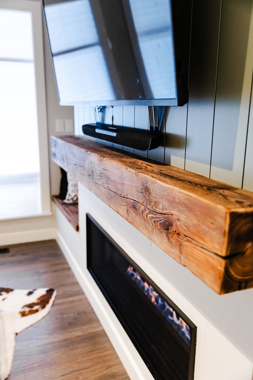 Shiplap paneling and custom cabinetry around gas fireplace feature wall in Calgary