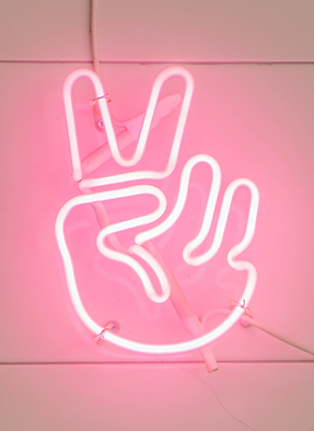 Neon sign of hand holding up two fingers ✌️