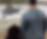 Man in plaid jacket and child stand by a lake, with text "Be Present" above. Background features trees and overcast sky. Calm mood.