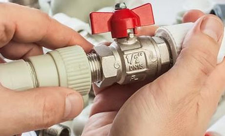 Plumber installing pipe fitting