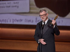 Paul Thomas Anderson holding an Academy Award while speaking on stage at the 2026 Oscars.