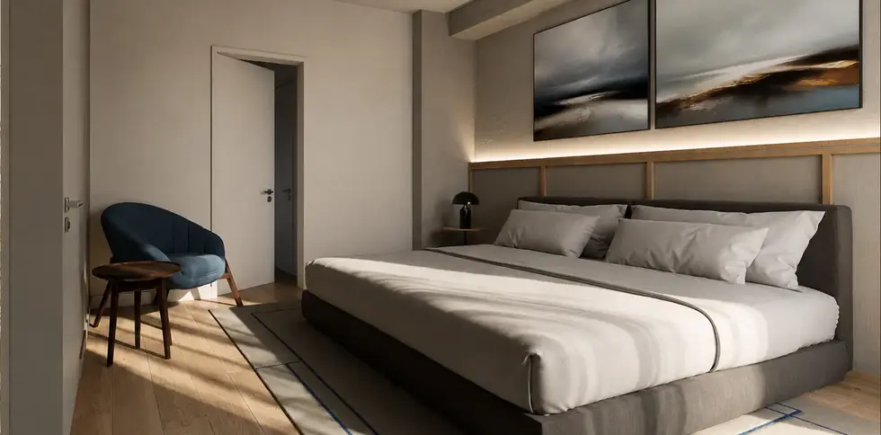 Modern bedroom in the Sose 25 residential building in Yerevan, designed with a large bed, lounge chair, warm wood flooring and contemporary wall lighting.