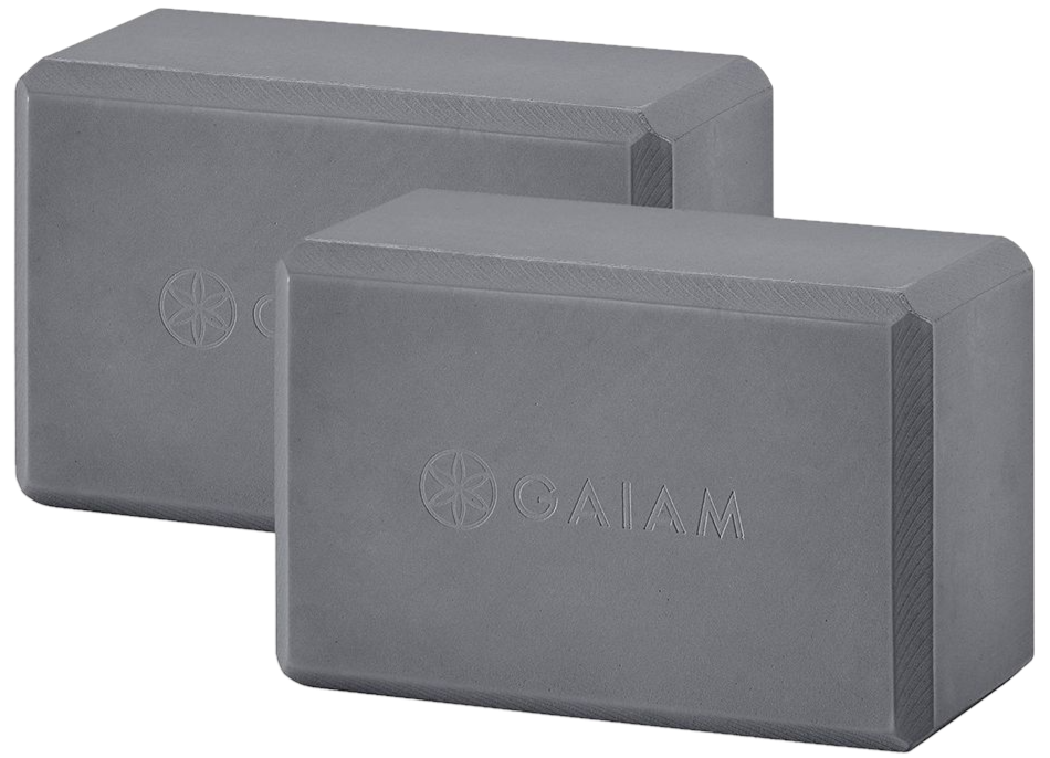 Two gray yoga blocks with the brand name "GAIAM" displayed. The blocks have beveled edges and a subtle decorative pattern in a plain setting.
