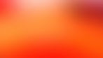 fuzzy grainy orang-ish red-ish and pink gradient with spherical hues of light. It creates