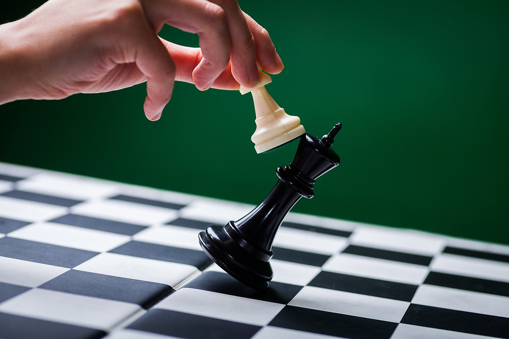 Der Beitrag heißt: „Wissen ist Macht – und muss deshalb geteilt werden!“ Das Bild zeigt eine Hand, die mit einer weißen Schachfigur eine schwarze Schachfigur umwirft.