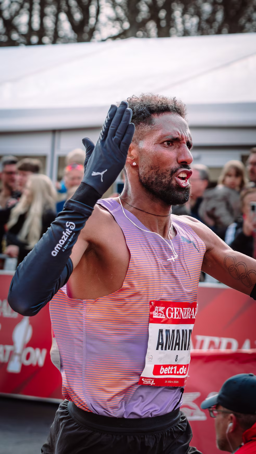 German record runner Petros Amanal clapping and celebrating during the Generali Berlin Half Marathon 2026.