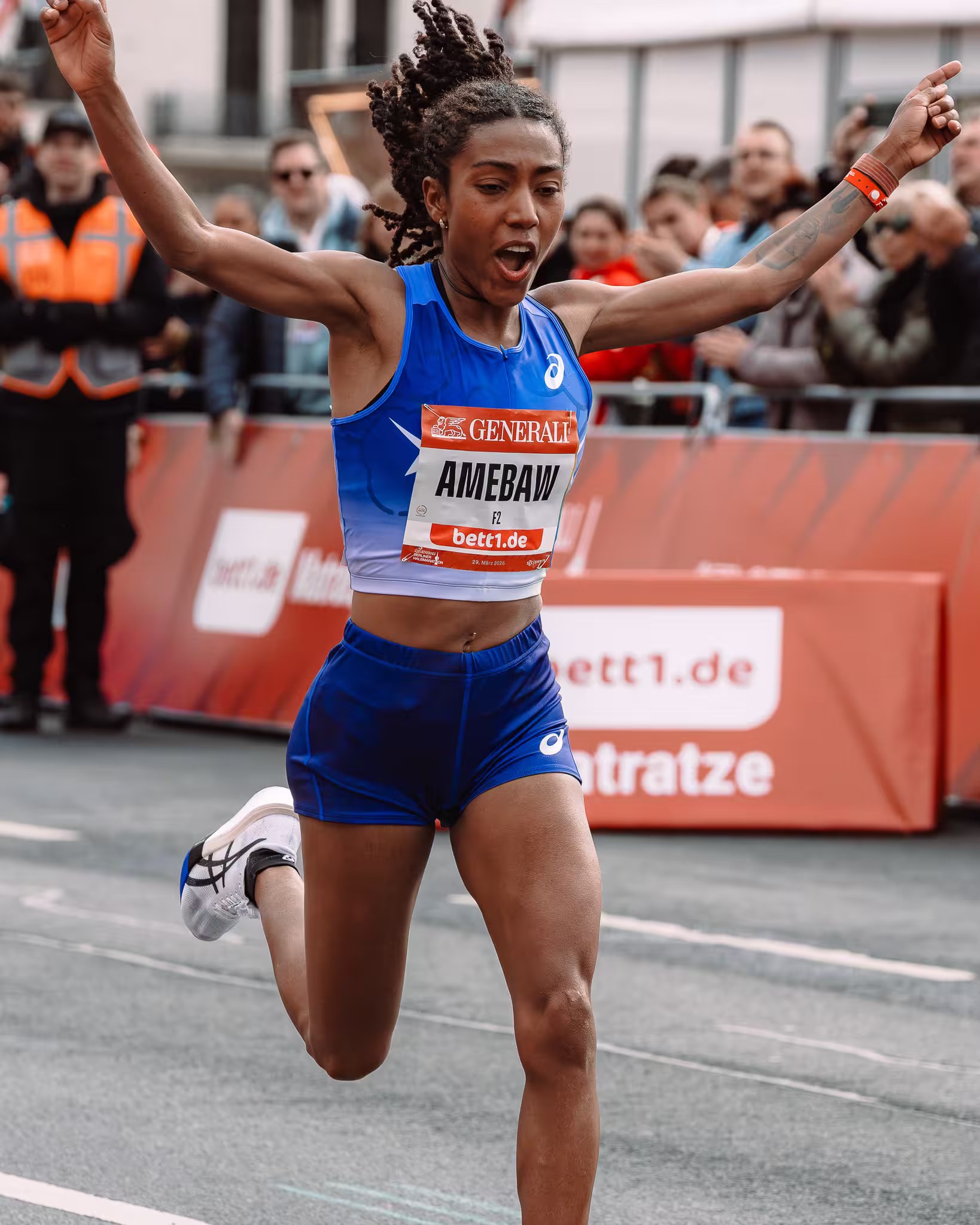 Elite runner Amebaw crossing the finish line in victory at the Berlin Half Marathon 2026.
