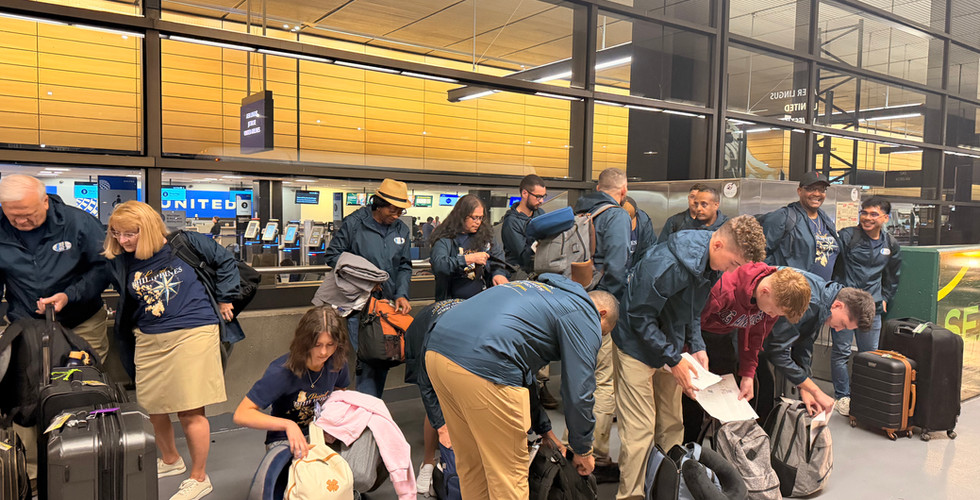 Project Philippines team members unload personal luggage and ministry-material bags before departure.