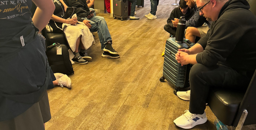 Project Philippines team members wait near their gate at Seattle–Tacoma International Airport.