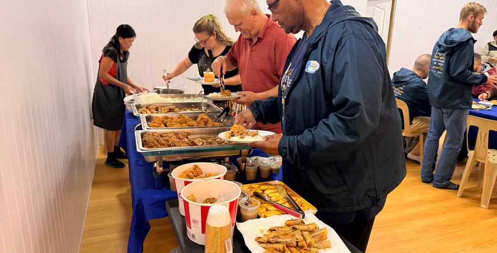 Members of the Lighthouse church family serve dinner to the Project Philippines team.