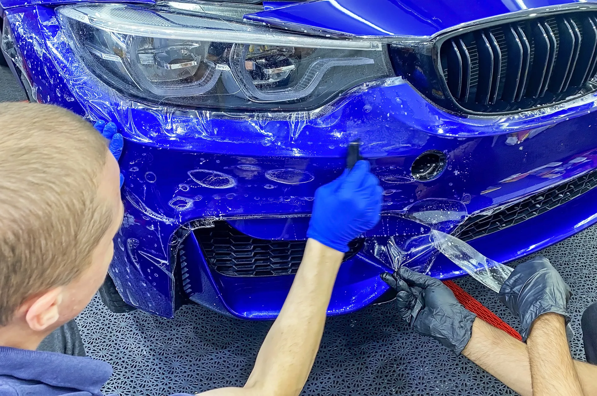 BMW PPF film being installed