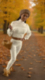 Eye-level view of a layered fall outfit with a camel coat and knit sweater