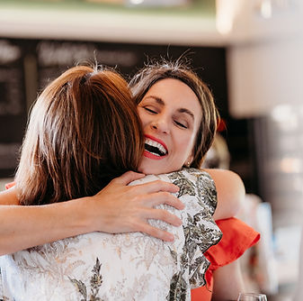 Women hugging at relaxed female founder networking event Surrey