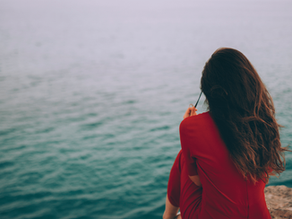woman enjoying solitude at the ocean