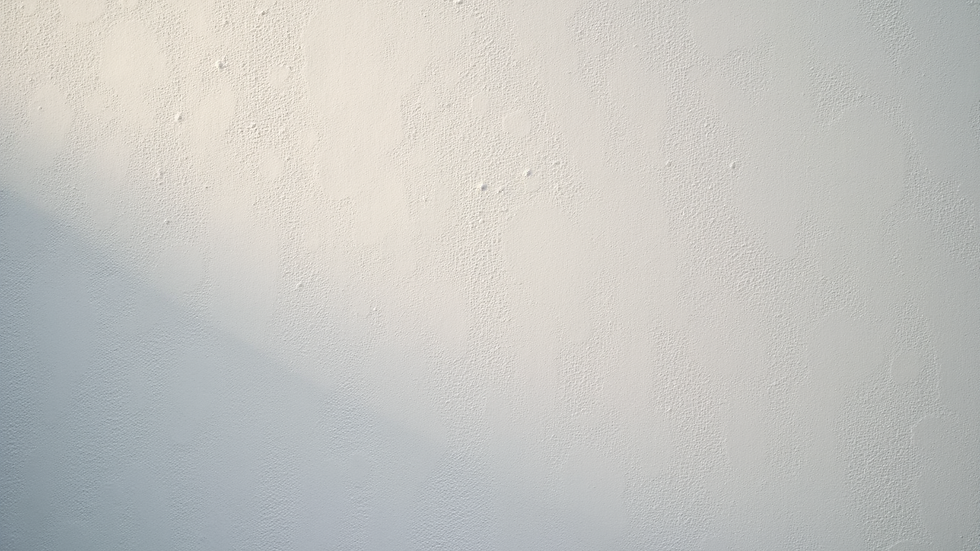 Close-up view of textured stucco wall surface